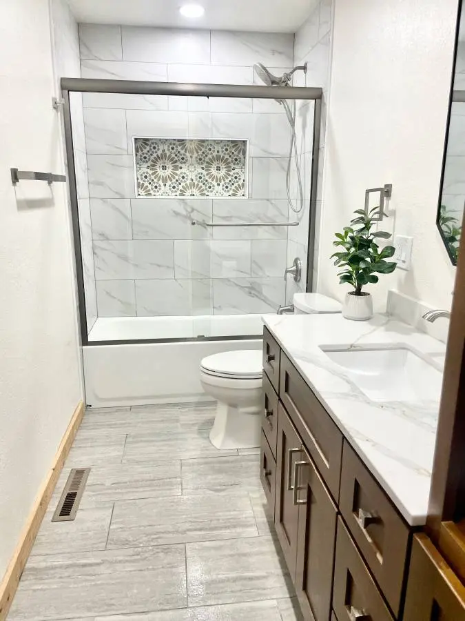 Marble-look bathroom tile installed with clean modern detailing