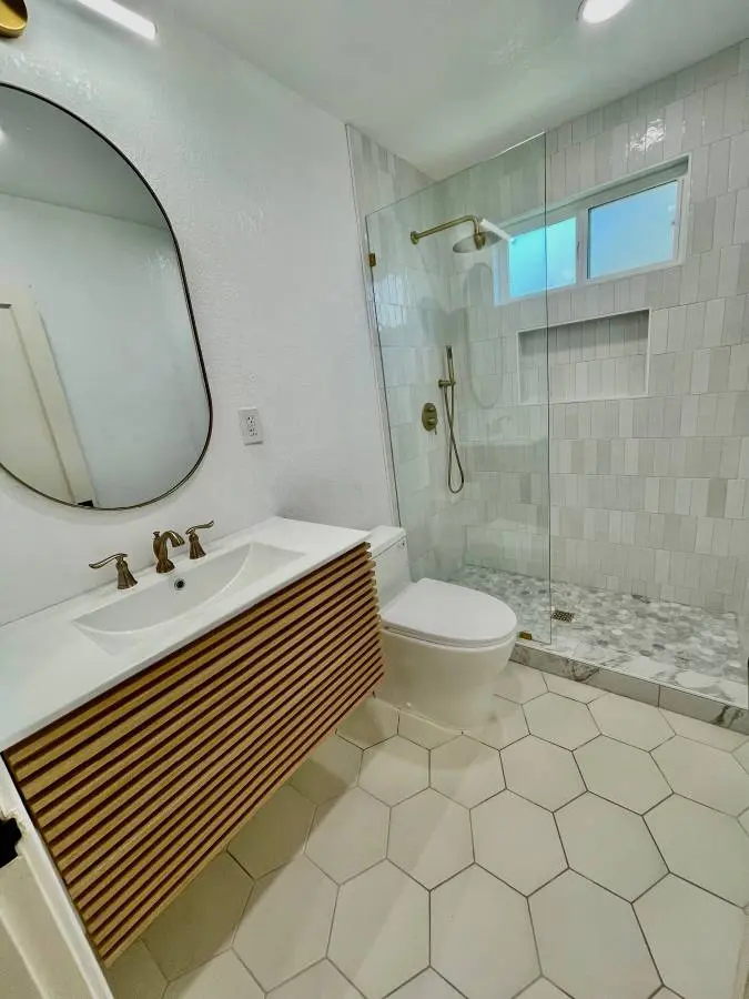 Modern bathroom with a wood vanity and coordinated shower finishes